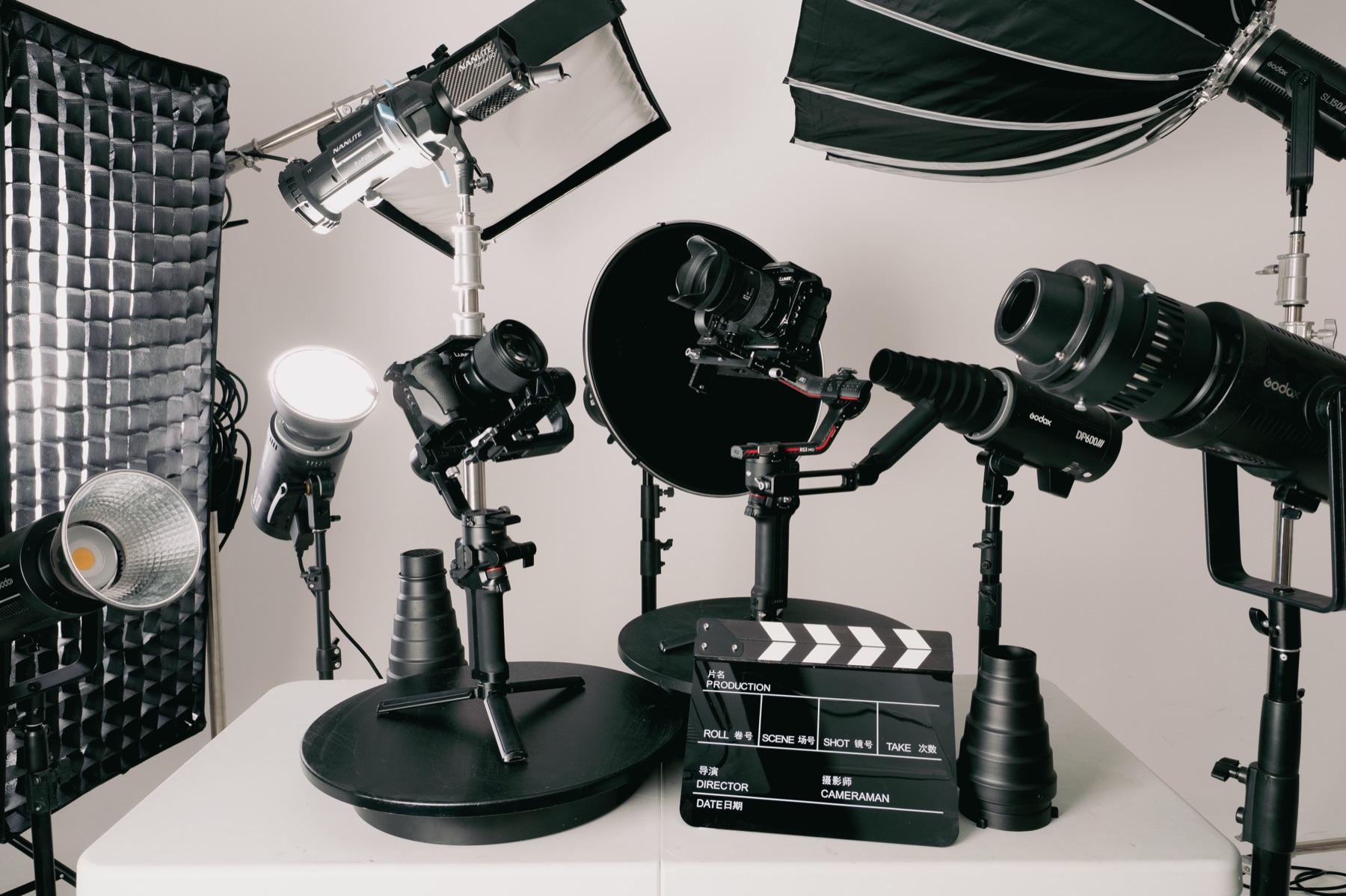 Studio table with cameras, lighting and clapperboard